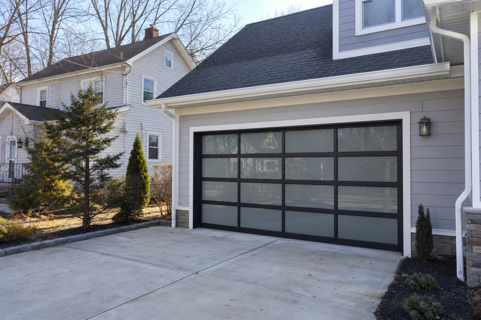 Suburban Teaneck garage exterior with a modern door and driveway in daylight